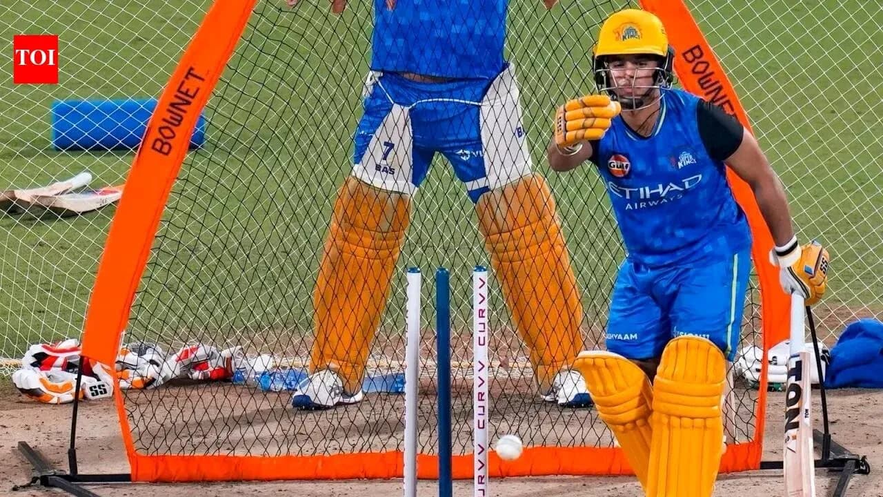Batsman practicing in nets during cricket training session Batsman practicing in nets during cricket training session