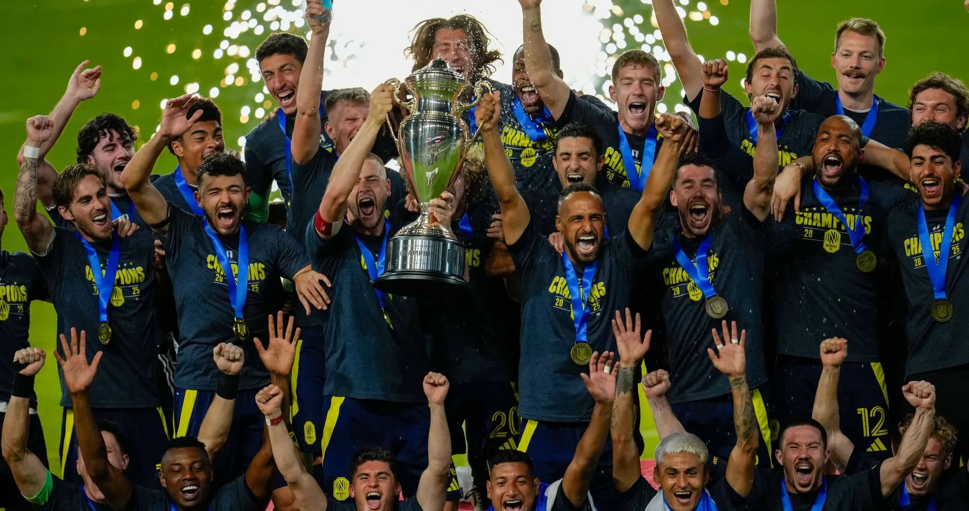 Team celebrating with trophy after championship victory Team celebrating with trophy after championship victory