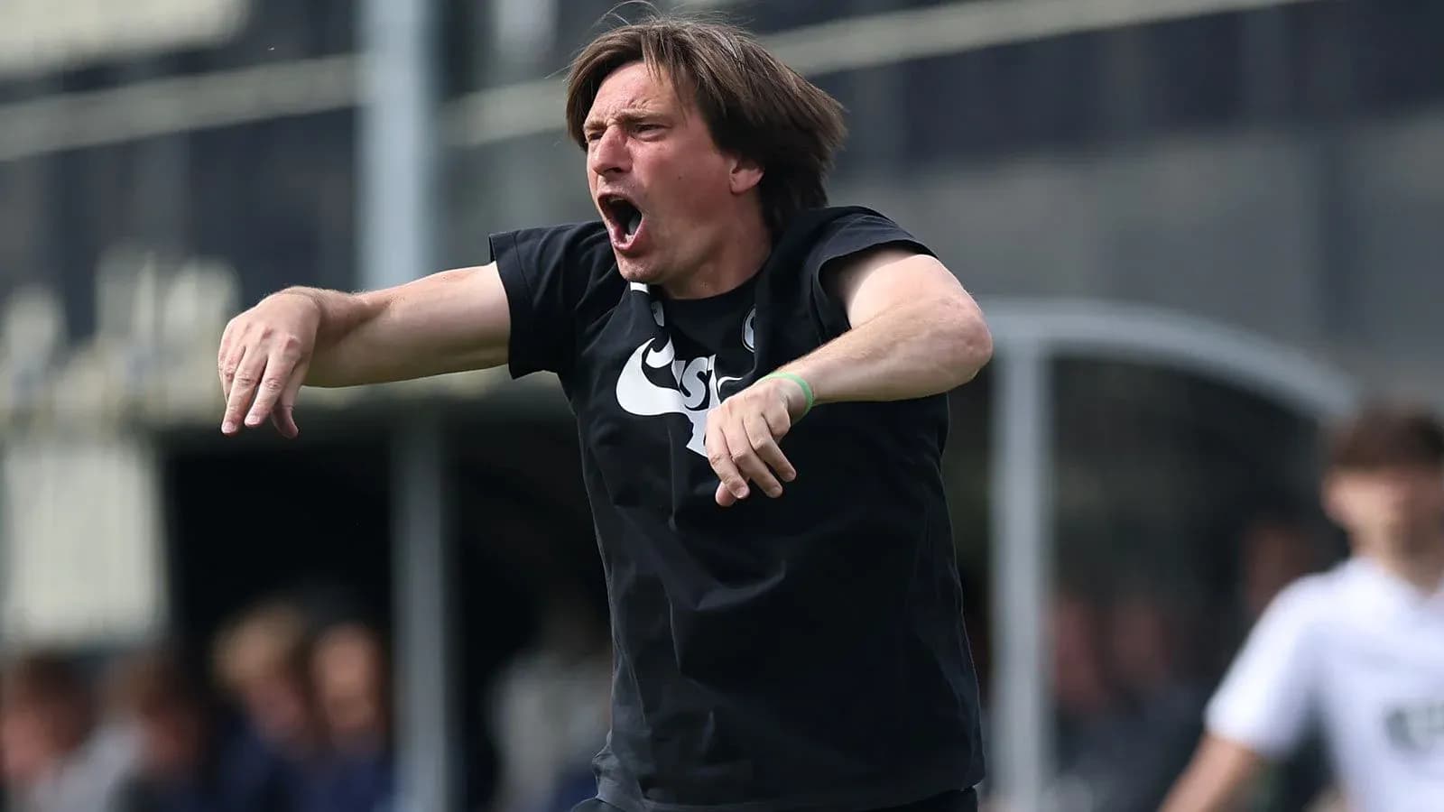 Coach gesturing passionately during a match Coach gesturing passionately during a match
