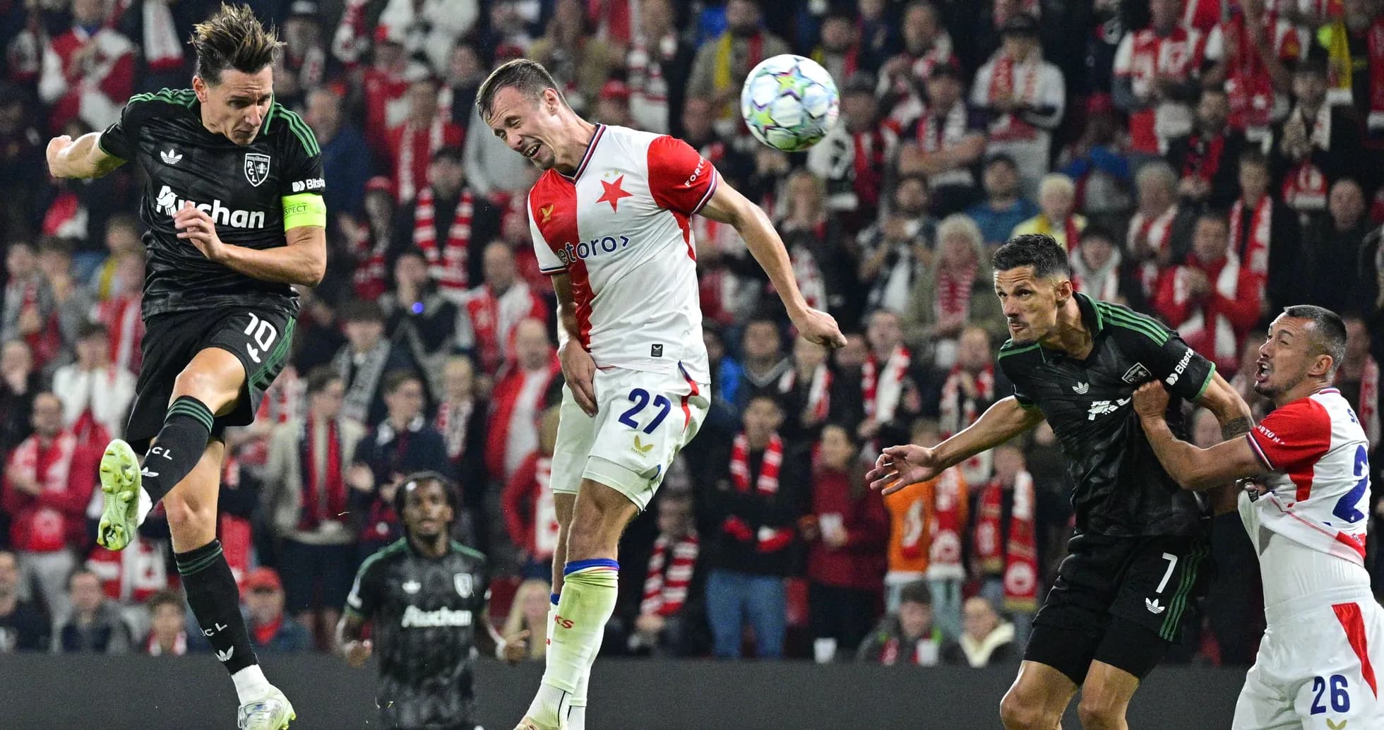 Players contesting for the ball during a match Players contesting for the ball during a match