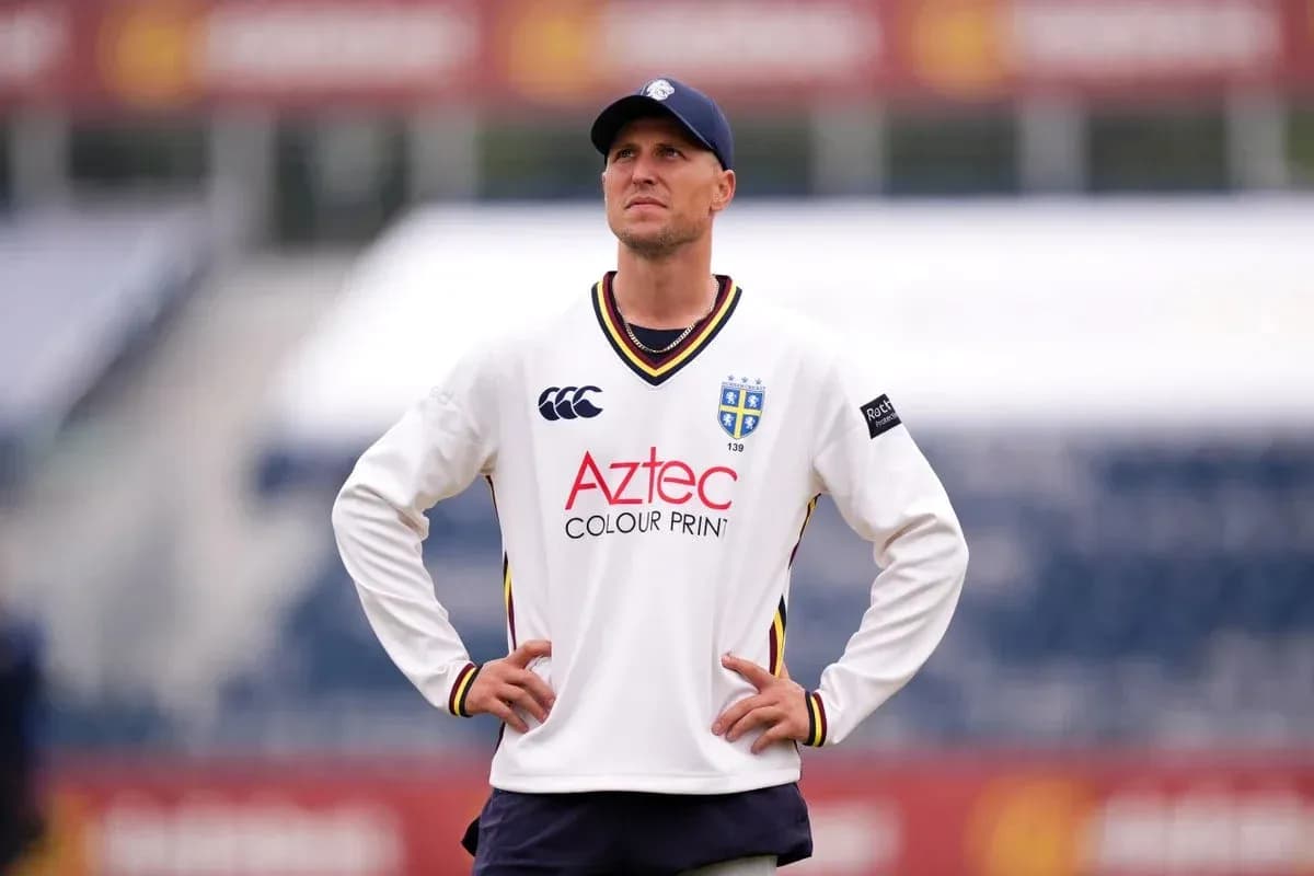 Cricketer wearing team jersey on field Cricketer wearing team jersey on field