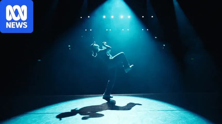 Dancer performing under dramatic stage lighting Dancer performing under dramatic stage lighting