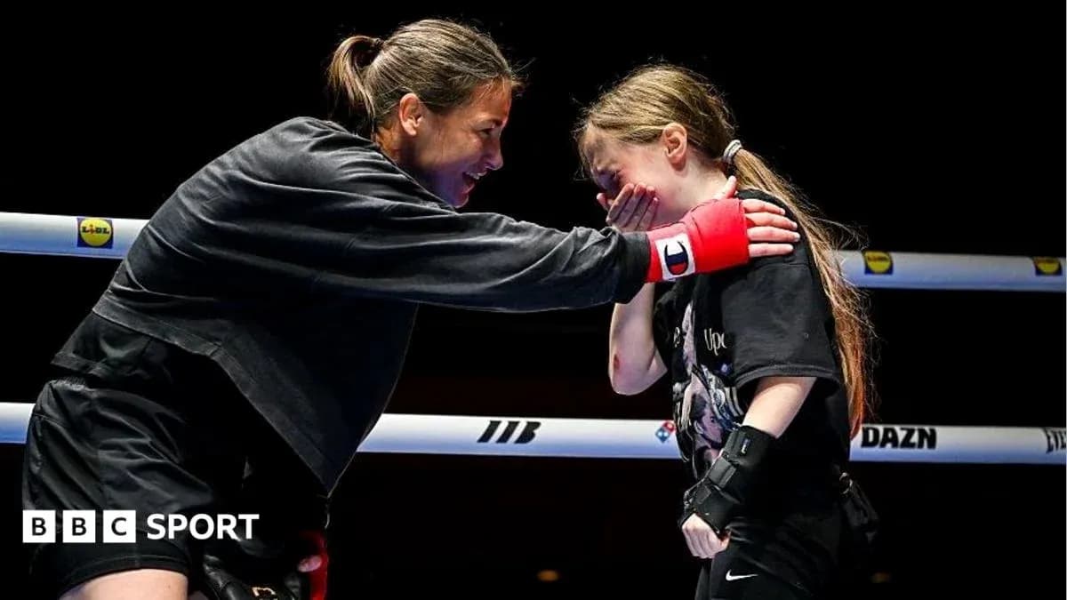 Boxer encouraging young girl in training ring Boxer encouraging young girl in training ring