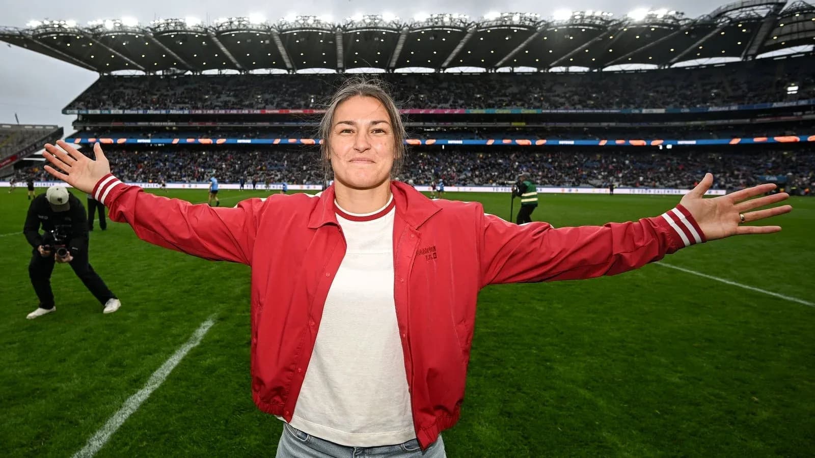 Woman celebrating on the field at a stadium Woman celebrating on the field at a stadium
