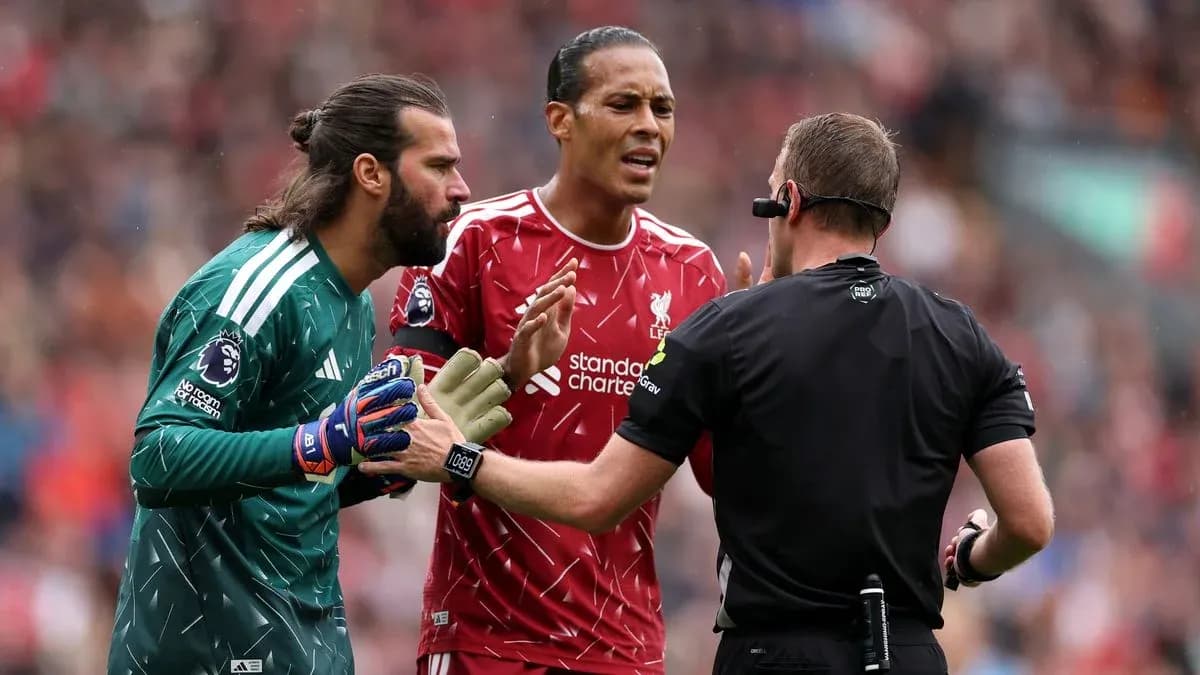 Liverpool players discussing with the referee during match Liverpool players discussing with the referee during match