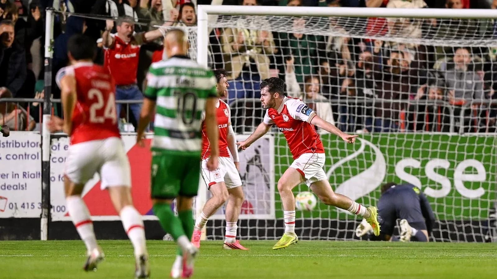 Player celebrating a goal with teammates in match Player celebrating a goal with teammates in match