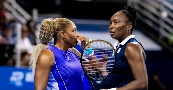 Two female tennis players discussing during a match Two female tennis players discussing during a match