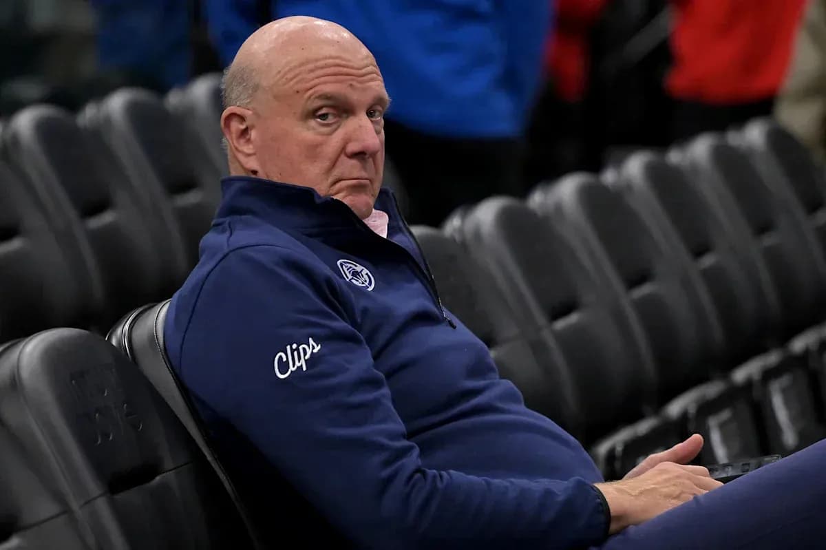Man sitting in empty arena wearing Clippers attire Man sitting in empty arena wearing Clippers attire