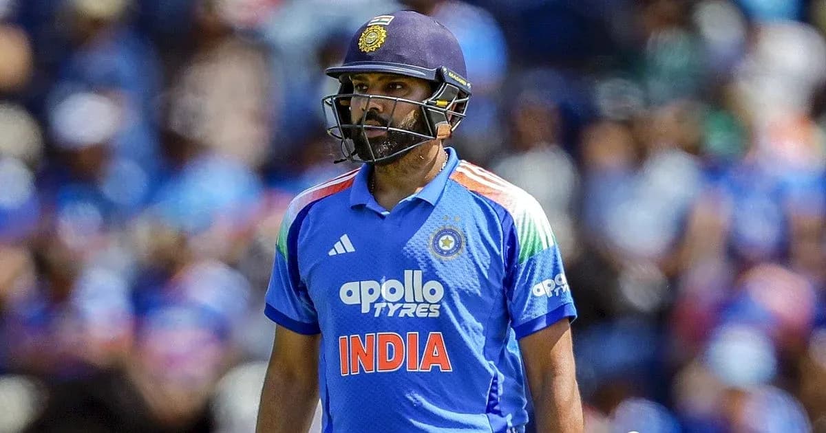 Cricketer in blue jersey walking on field Cricketer in blue jersey walking on field