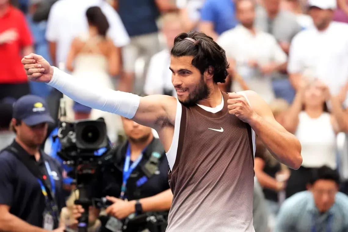 Tennis player celebrating victory with raised fist Tennis player celebrating victory with raised fist