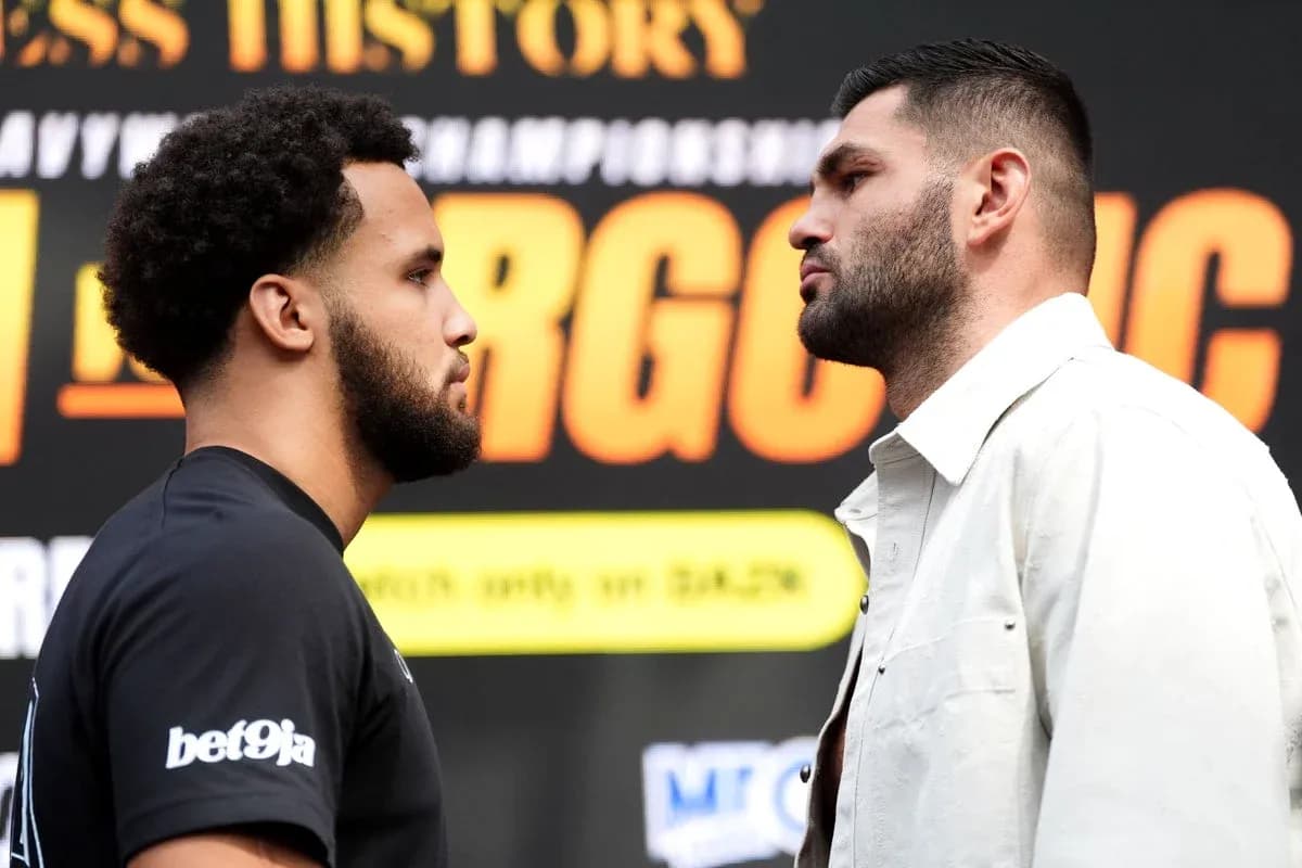 Two boxers facing off at a promotional event Two boxers facing off at a promotional event