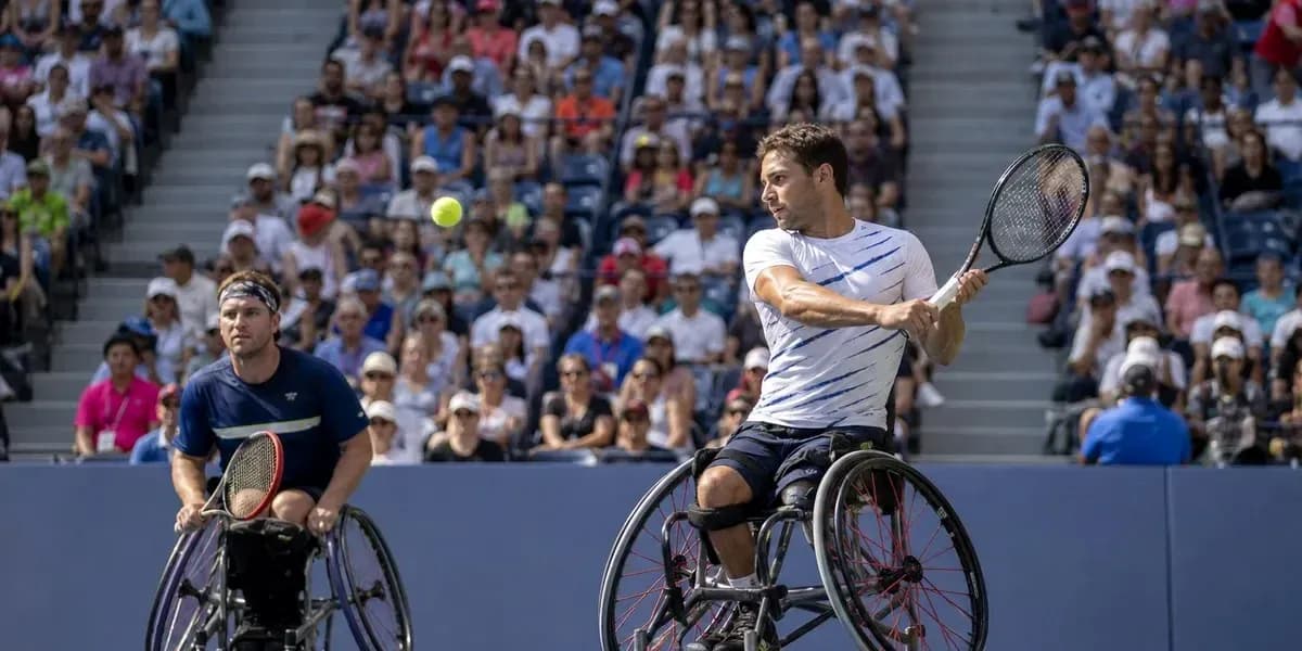 Two wheelchair tennis players competing in a match Two wheelchair tennis players competing in a match