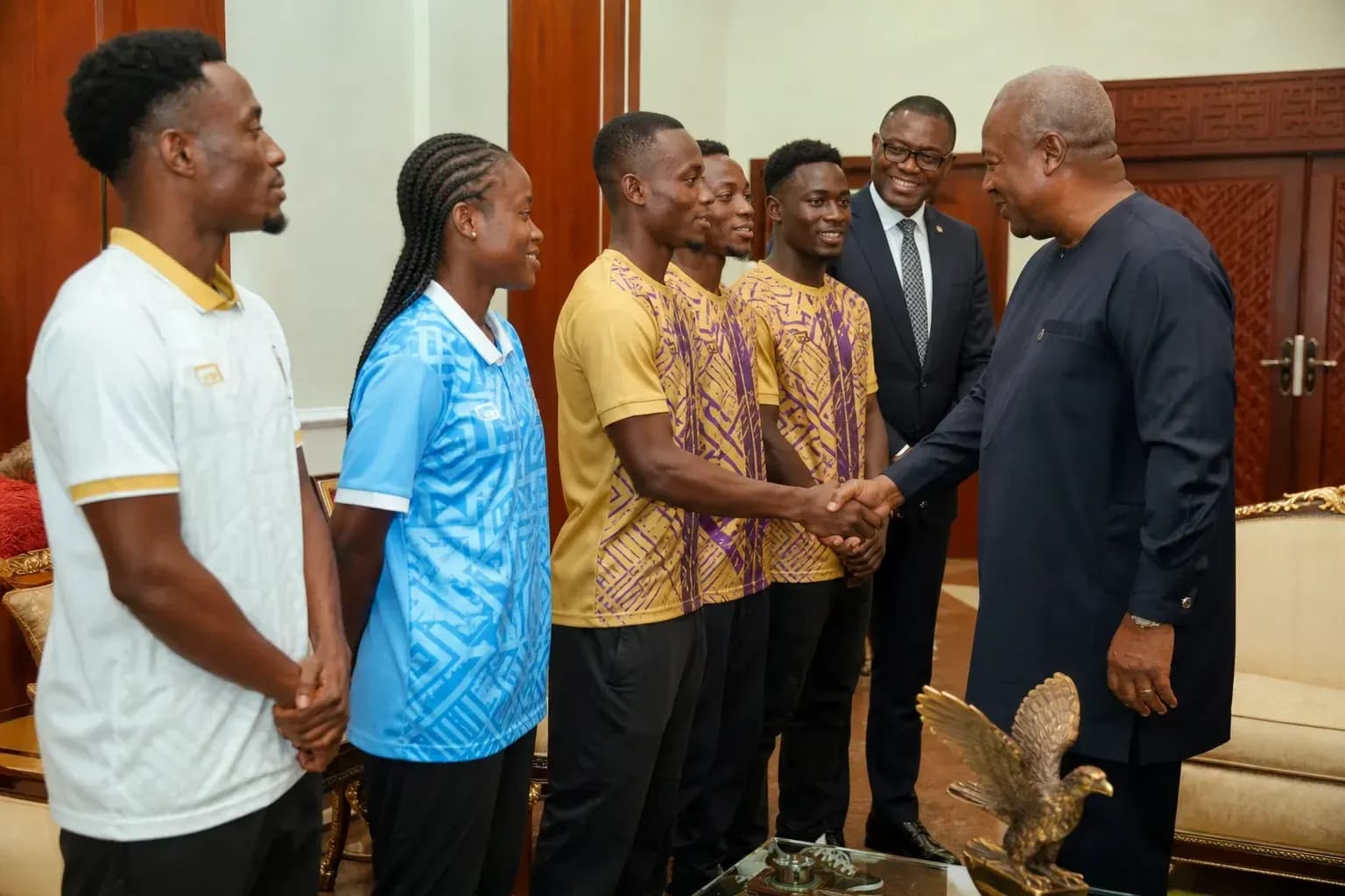 Athletes meeting with a dignitary in an office Athletes meeting with a dignitary in an office