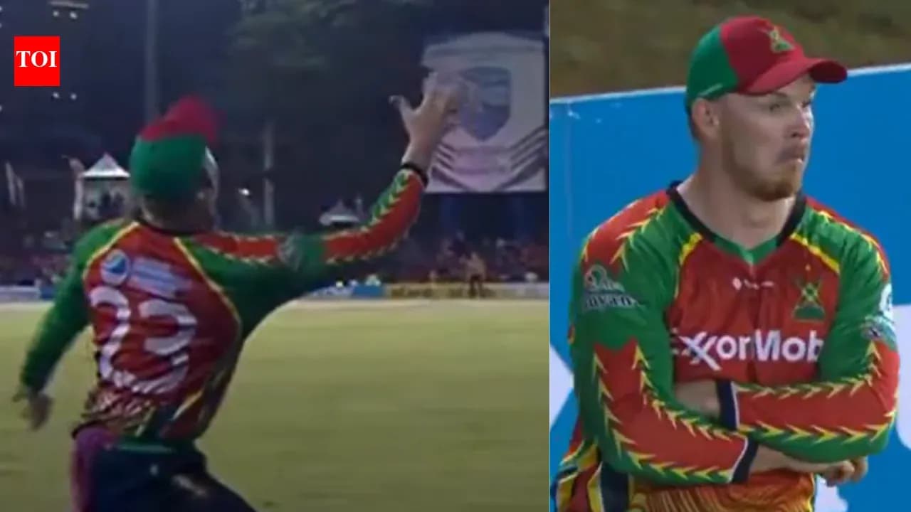 Cricketer attempting a catch during match action Cricketer attempting a catch during match action
