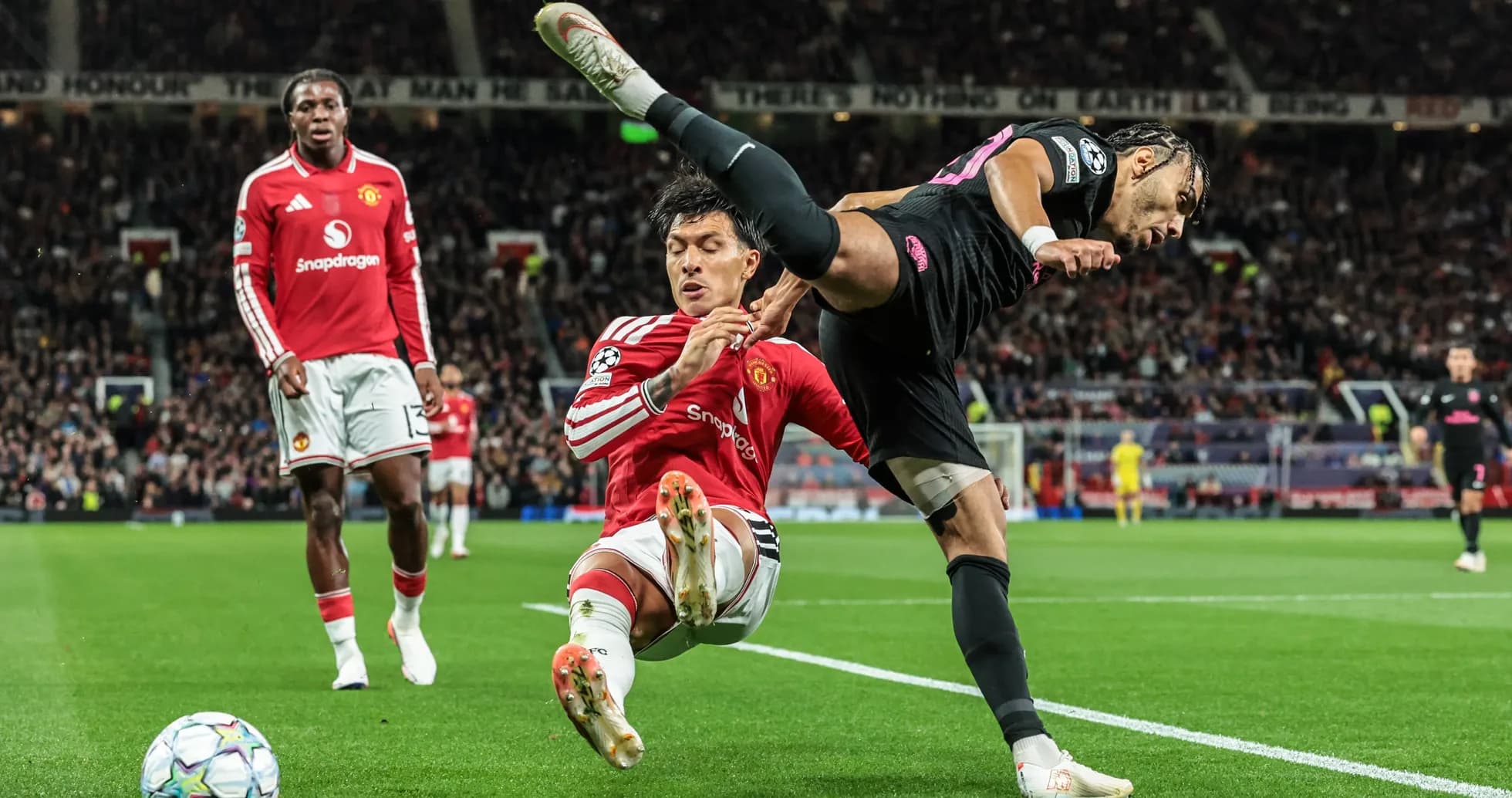 Player tackling opponent during match at Old Trafford Player tackling opponent during match at Old Trafford