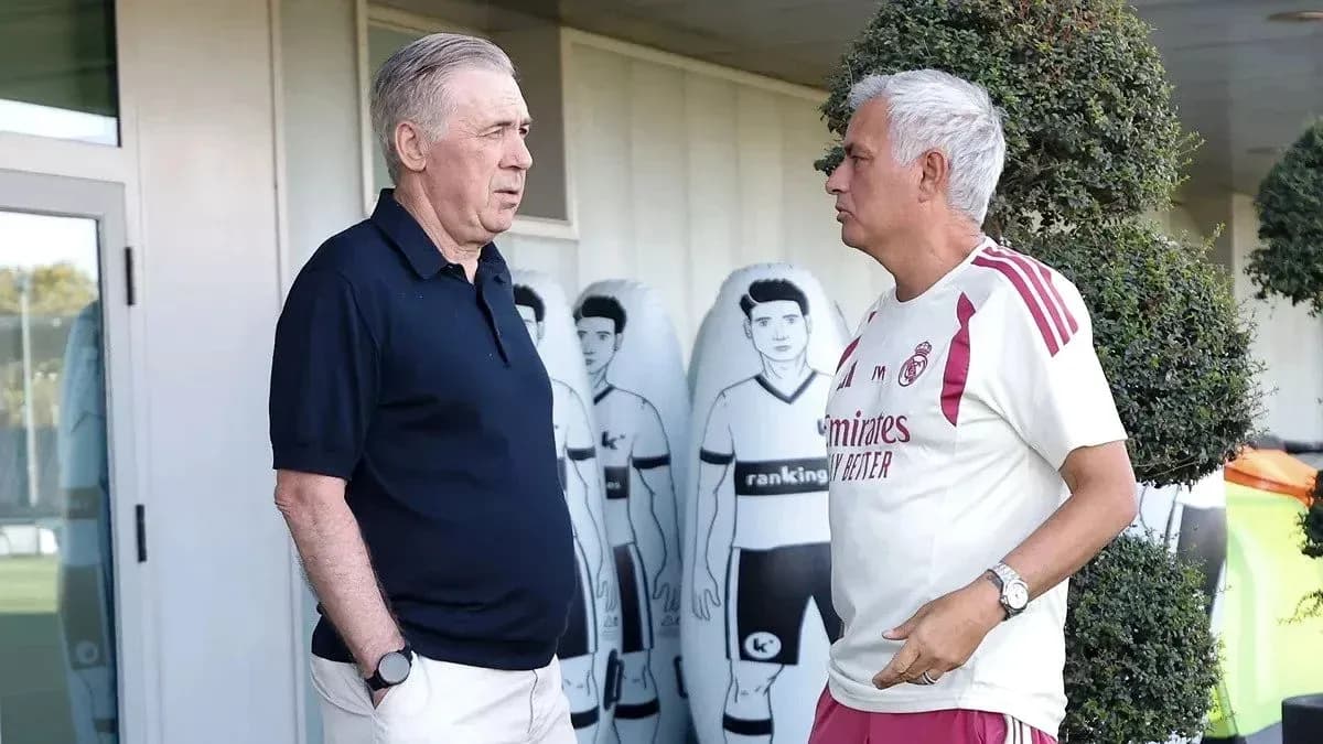 Two coaches discussing near training equipment Two coaches discussing near training equipment