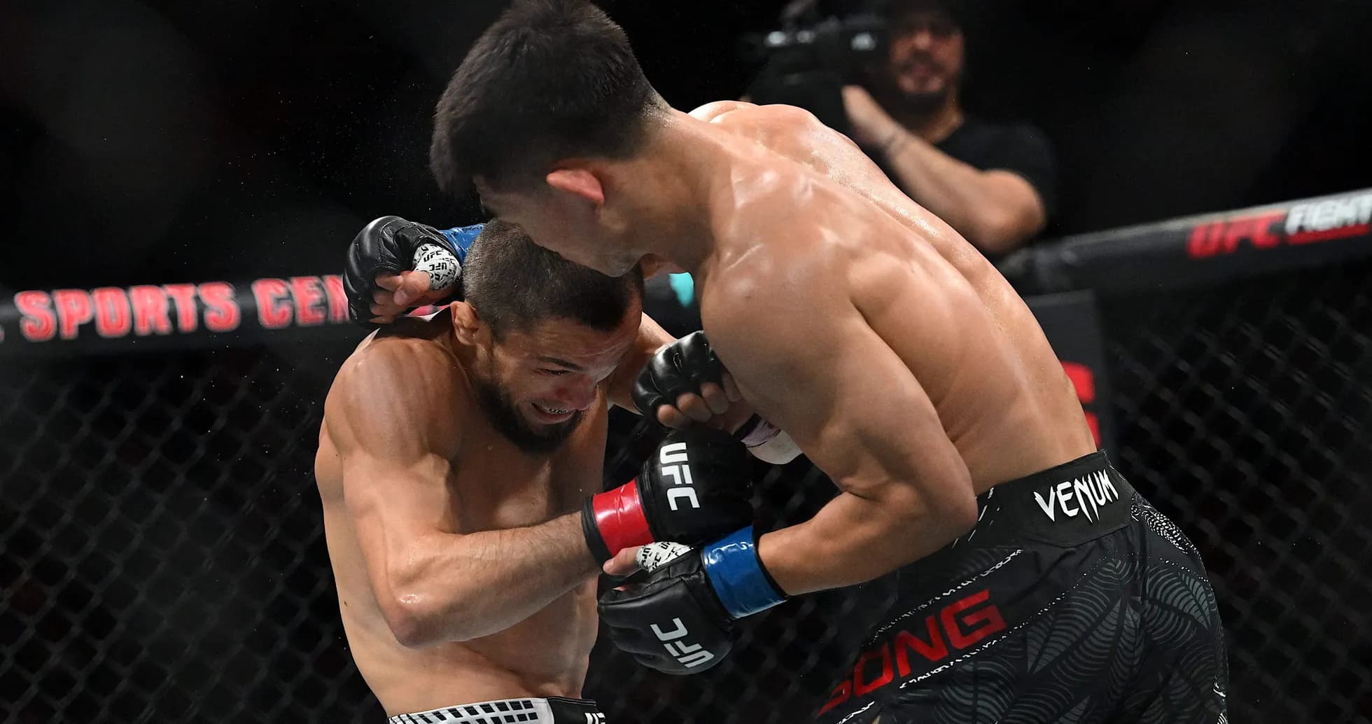 Two fighters exchanging punches in UFC match Two fighters exchanging punches in UFC match
