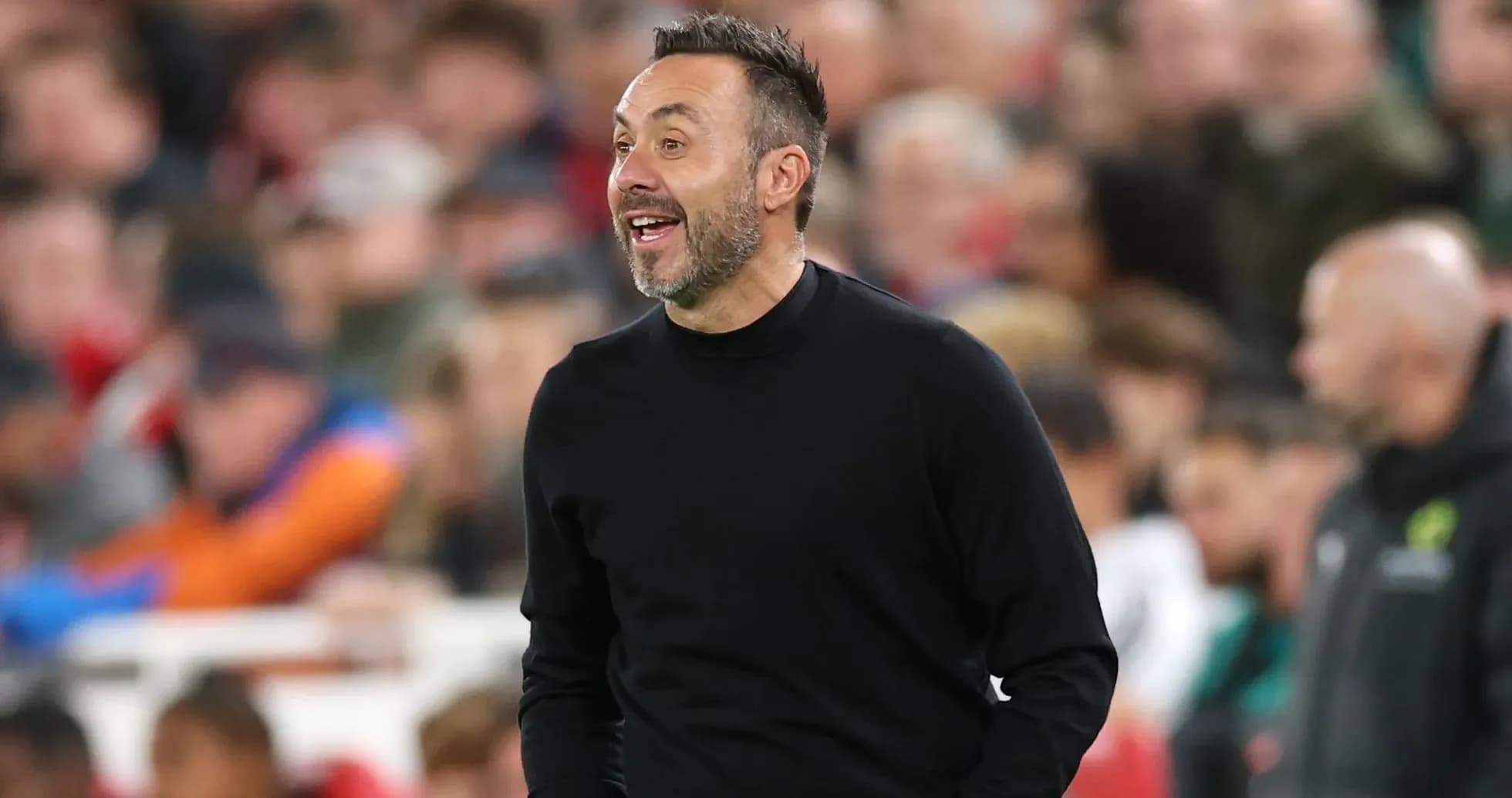 Manager coaching during a match with spectators behind Manager coaching during a match with spectators behind