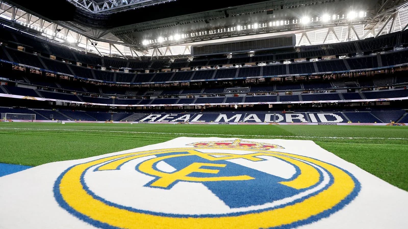 Real Madrid logo on pitch at stadium interior Real Madrid logo on pitch at stadium interior
